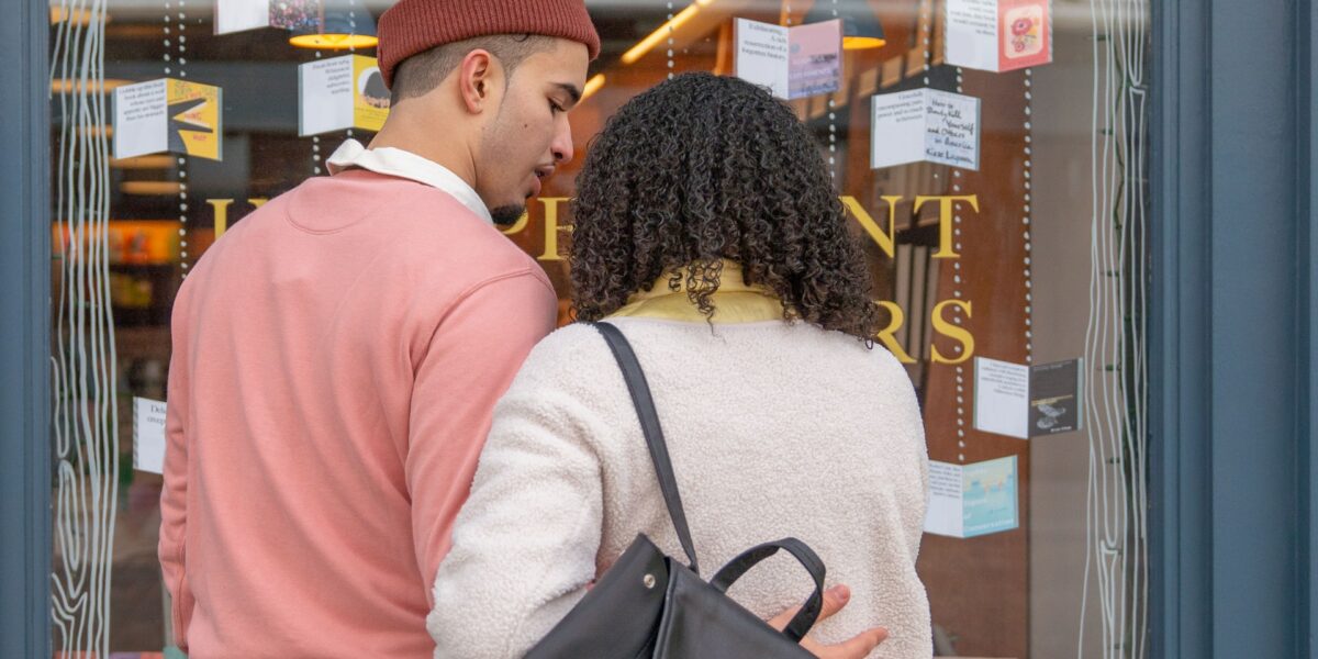 Male and female couple window shopping