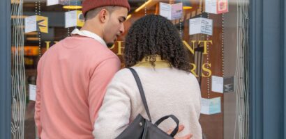 Male and female couple window shopping